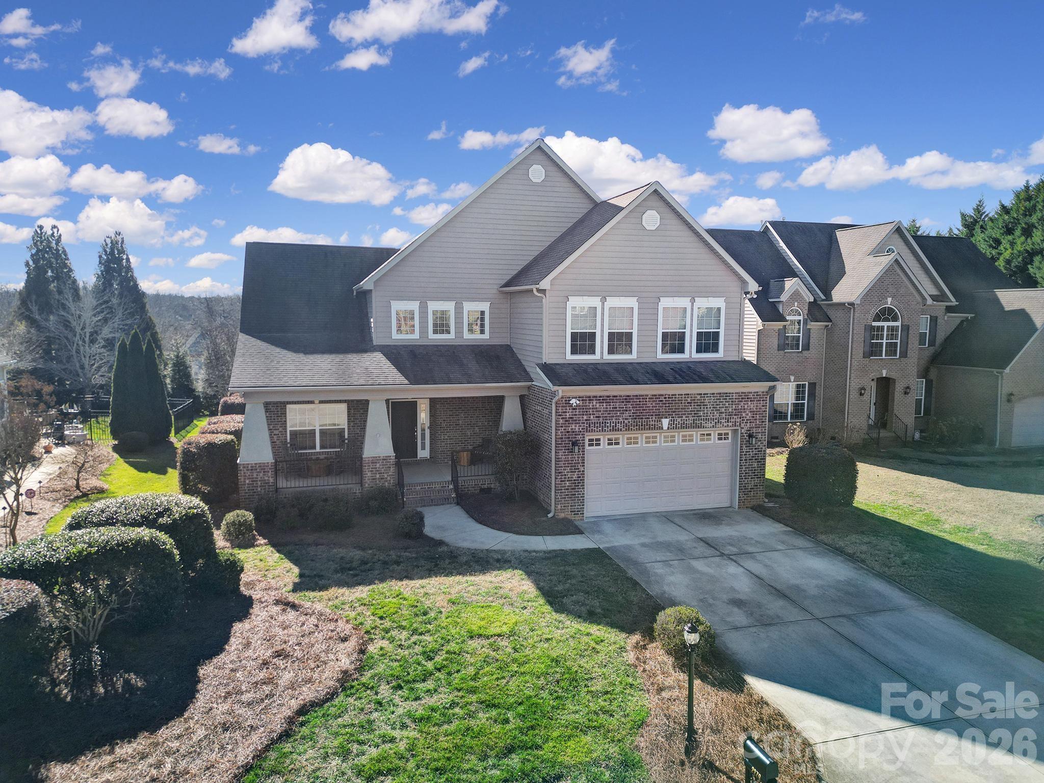 a front view of a house with a yard fire pit and outdoor seating