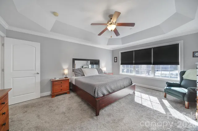 a bedroom with a bed couch and window