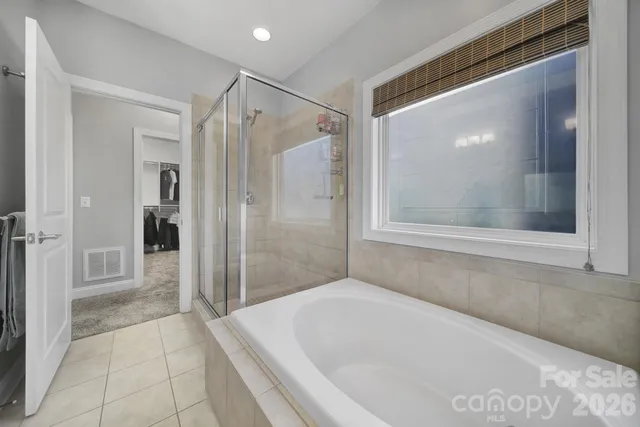a bathroom with a bathtub and a shower