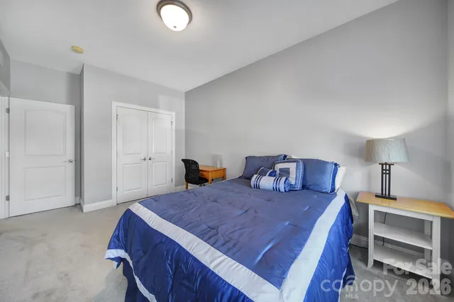 a bed room with a bed and a lamp