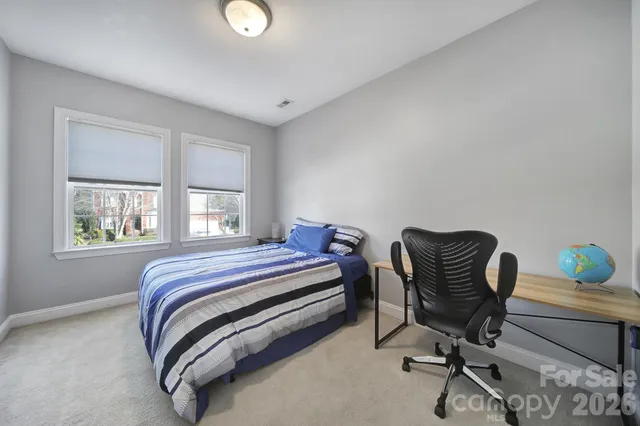 a bedroom with a bed and a desk