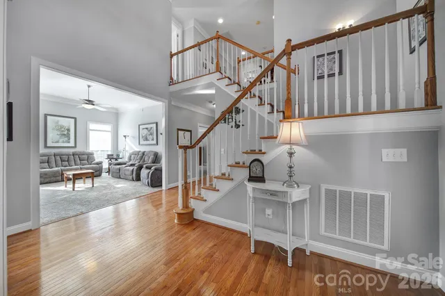 a view of entryway and hall with wooden floor
