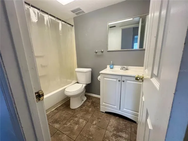 a bathroom with a sink a toilet and a shower
