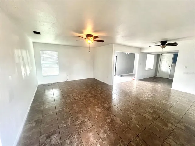 a view of a room with a window and a ceiling fan