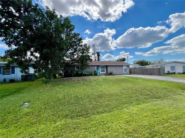 a front view of house with a garden