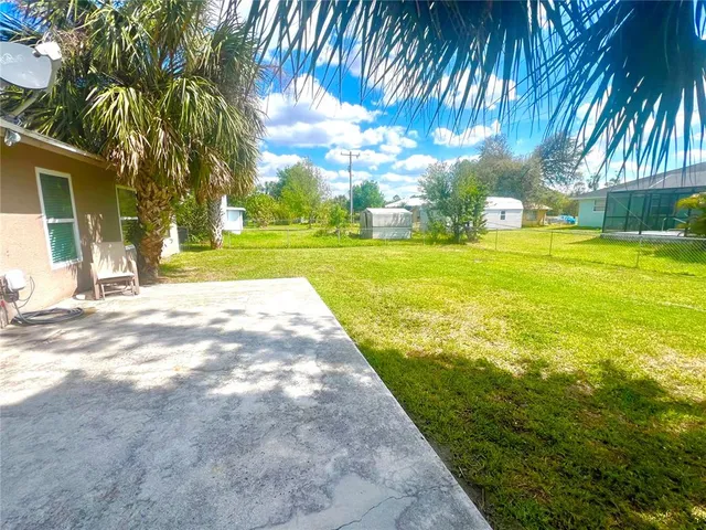 a view of yard with swimming pool and sitting area
