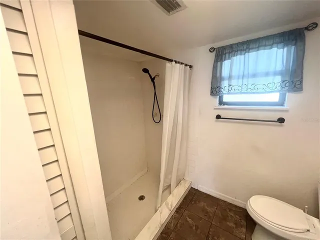 a bathroom with a shower and a toilet