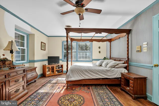 a bedroom with a bed couch and a window