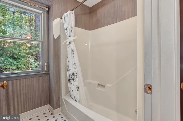 a bathroom with a bathtub and shower