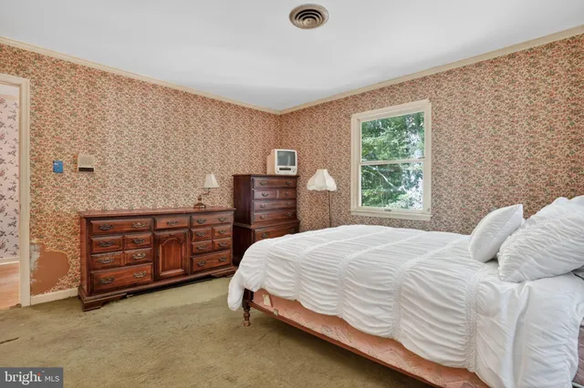 a bedroom with a bed and a dresser