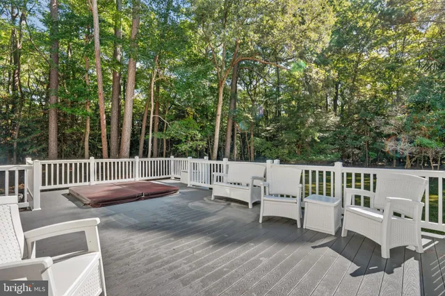 a view of backyard with deck and a garden