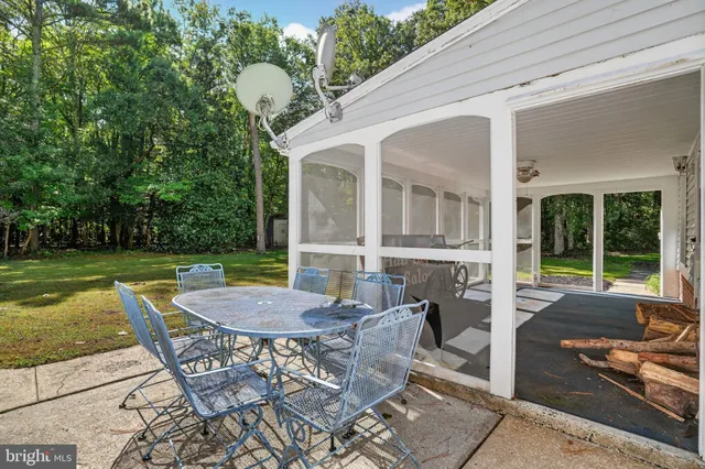 a view of a house with backyard sitting area and garden