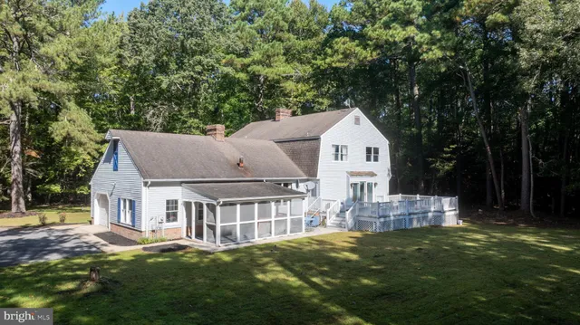 a front view of a house with a garden and yard