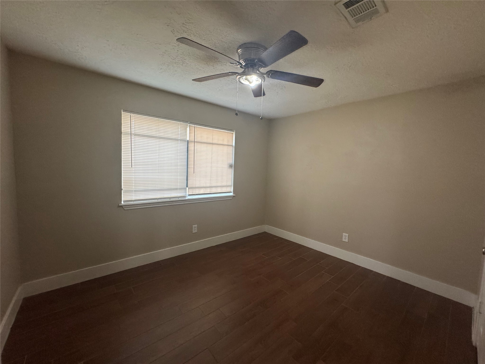 12811 Labelle Lane Houston, TX 77015 - Photo 11 of 14 an empty room with a window and a fan