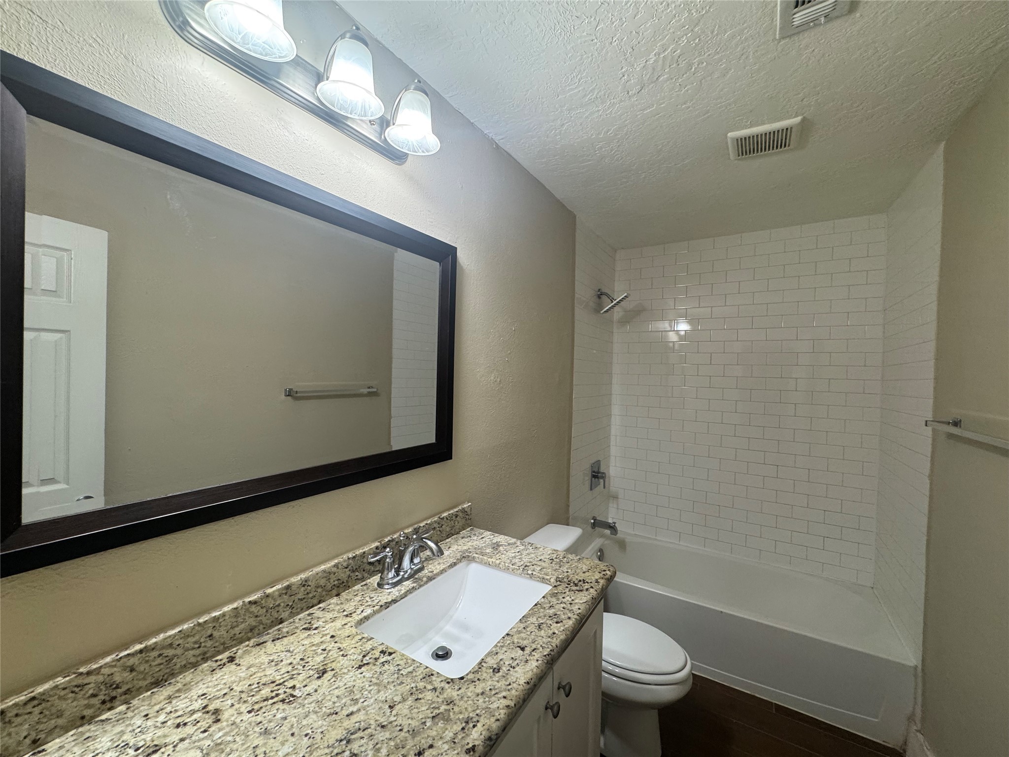 12811 Labelle Lane Houston, TX 77015 - Photo 12 of 14 a bathroom with a granite countertop sink a toilet and a mirror