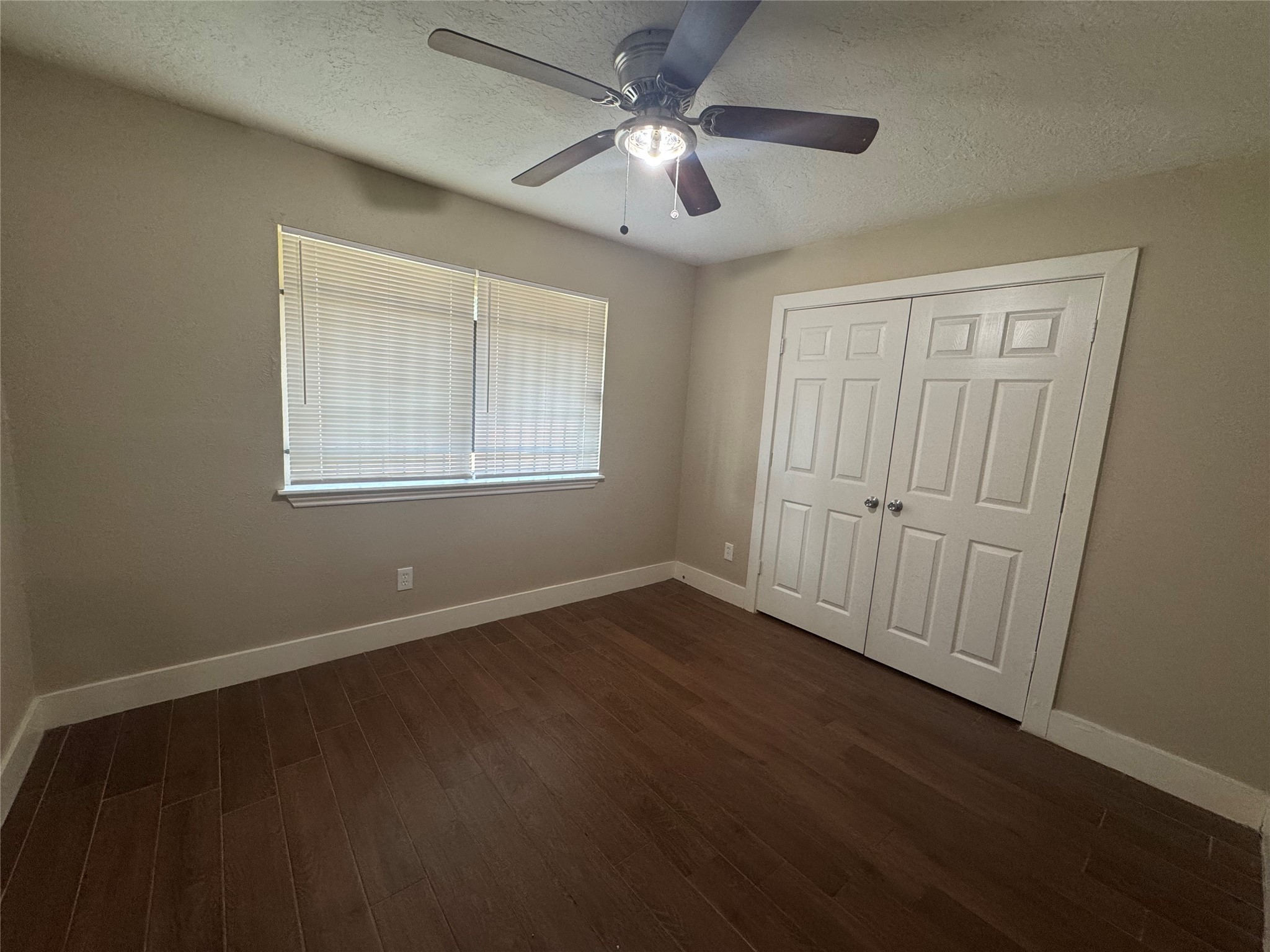 12811 Labelle Lane Houston, TX 77015 - Photo 13 of 14 a view of an empty room with wooden floor and a window