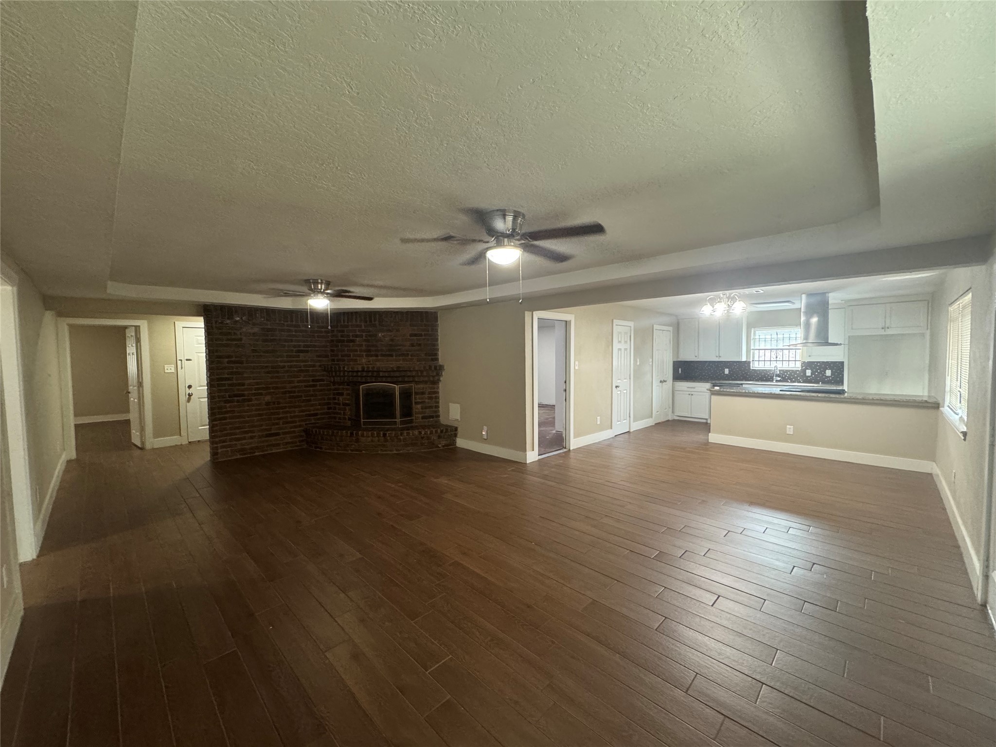 12811 Labelle Lane Houston, TX 77015 - Photo 3 of 14 a view of a livingroom with wooden floor and a kitchen