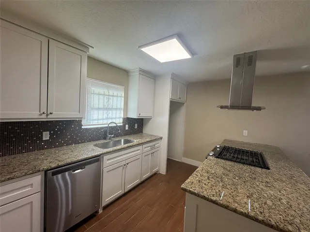 a kitchen with a sink and cabinets