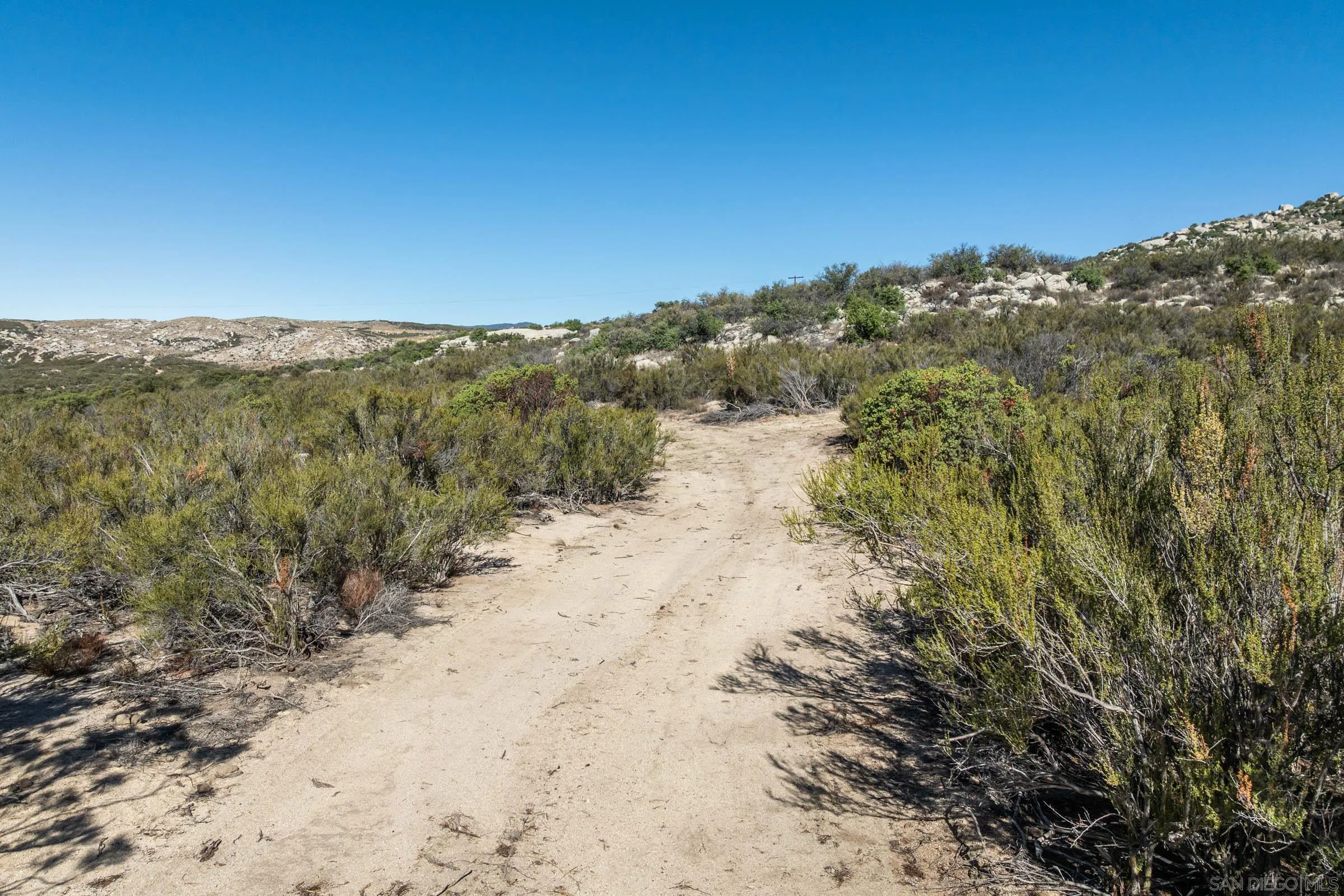 35613 Stagecoach Springs Road, Unit 466 Pine Valley, CA 91962 - Photo 27 of 28 a view of a dry yard with mountains in the background