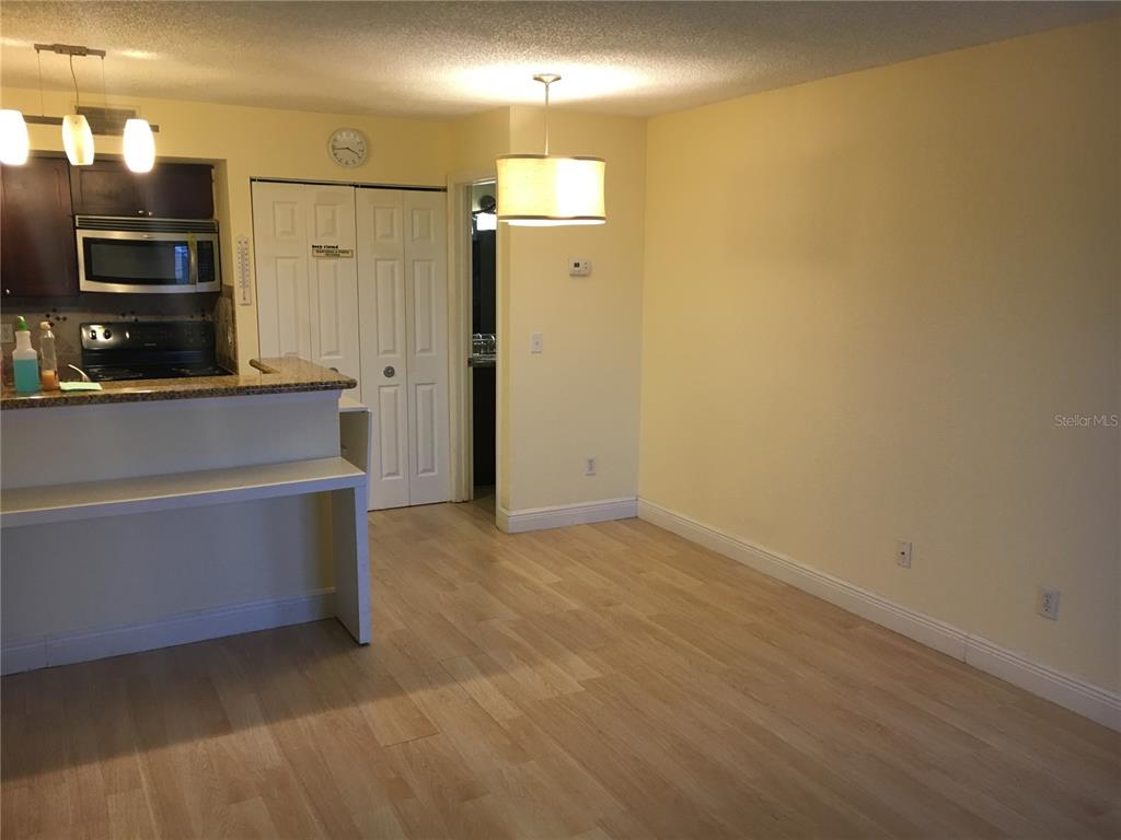 5152 Conroy Road, Unit 1314 Orlando, FL 32811 - Photo 4 of 9 a view of an empty room with a kitchen