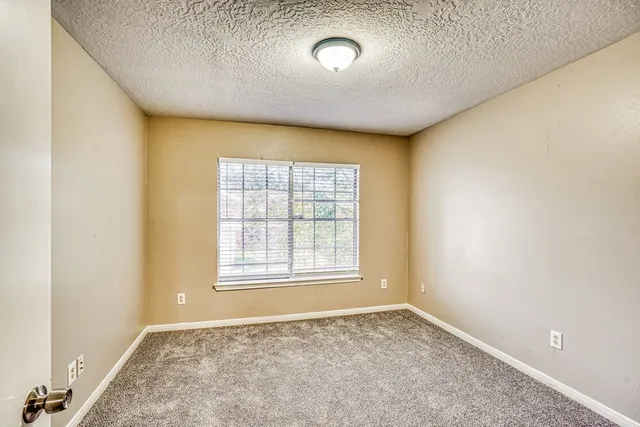 an empty room with a empty space and windows