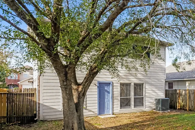a view of a house with a tree