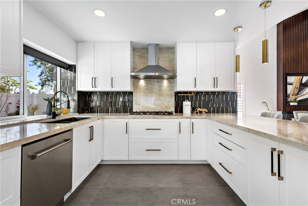 11 Bayside Irvine, CA 92614 - Photo 12 of 37 a kitchen with stainless steel appliances granite countertop a sink stove and refrigerator