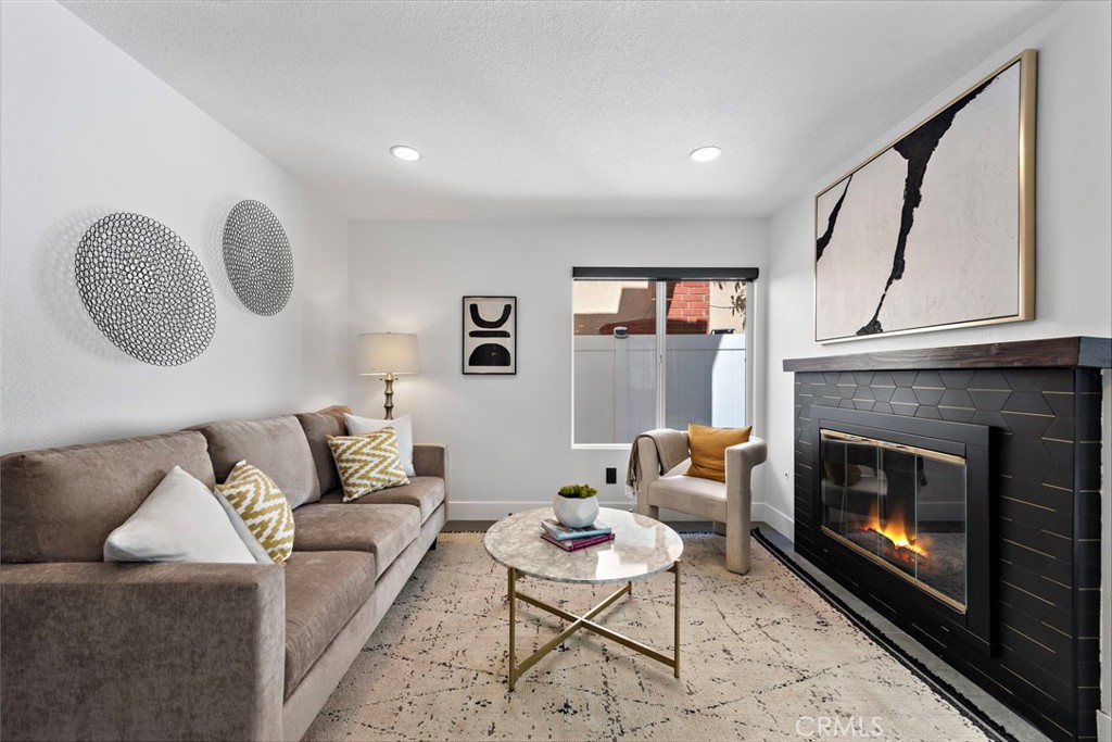 11 Bayside Irvine, CA 92614 - Photo 16 of 37 a living room with furniture and a fireplace