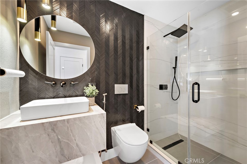 11 Bayside Irvine, CA 92614 - Photo 18 of 37 a bathroom with a toilet sink and mirror