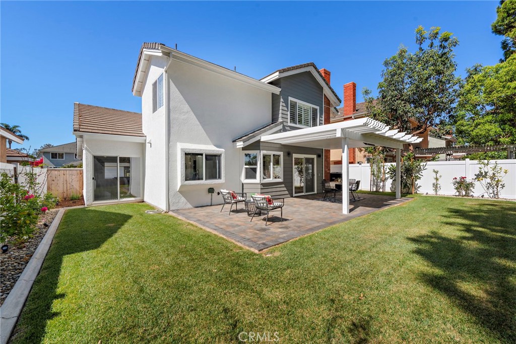 11 Bayside Irvine, CA 92614 - Photo 22 of 37 a view of a house with a patio and a garden