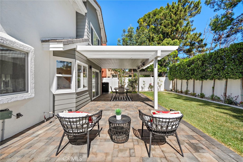 11 Bayside Irvine, CA 92614 - Photo 24 of 37 a view of a patio with a dining table and chairs with wooden floor
