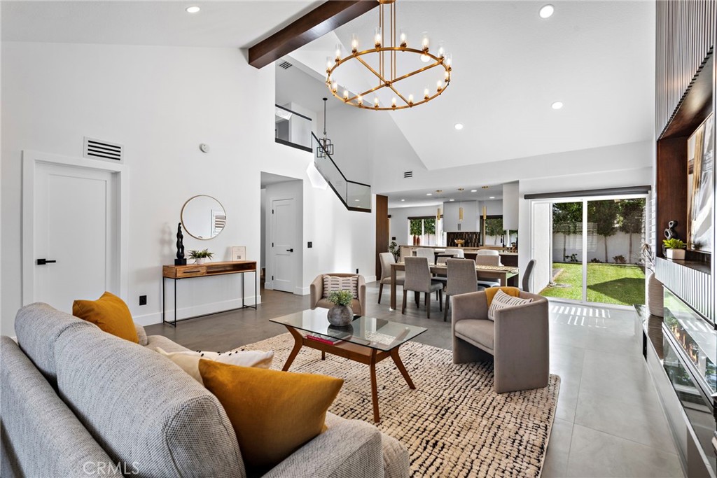 11 Bayside Irvine, CA 92614 - Photo 6 of 37 a living room with furniture a chandelier and a dining table