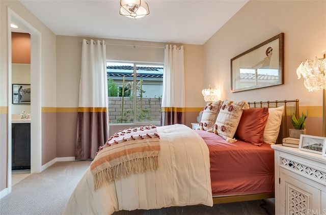 a bedroom with a bed and a painting on the wall