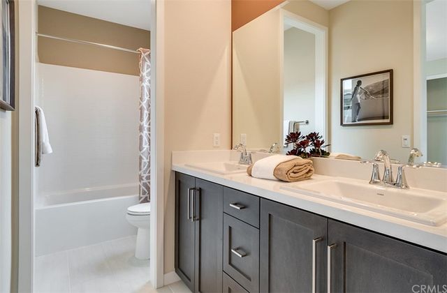 a bathroom with a tub sink and mirror