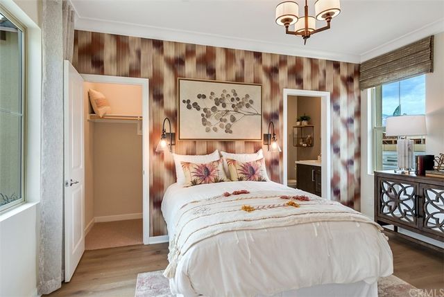 a bed sitting in a bedroom next to a bathroom