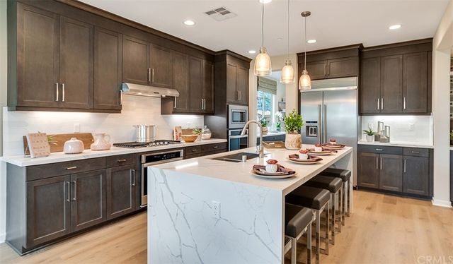 a kitchen with a sink stove and refrigerator