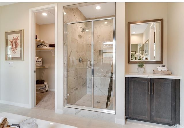 a bathroom with a shower sink and mirror