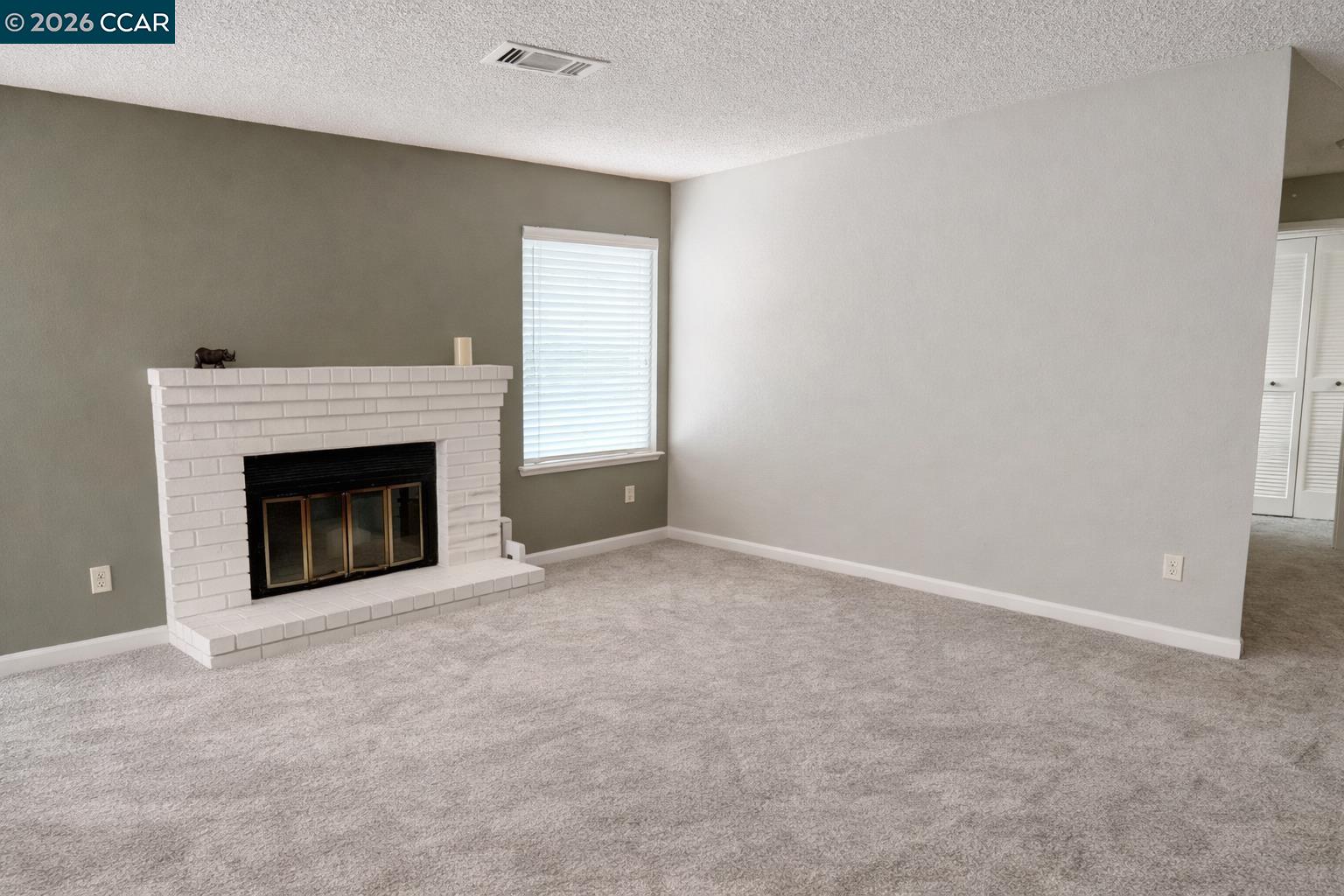 801 Dover Hercules, CA 94547 - Photo 2 of 19 a view of an empty room with a fireplace and a window