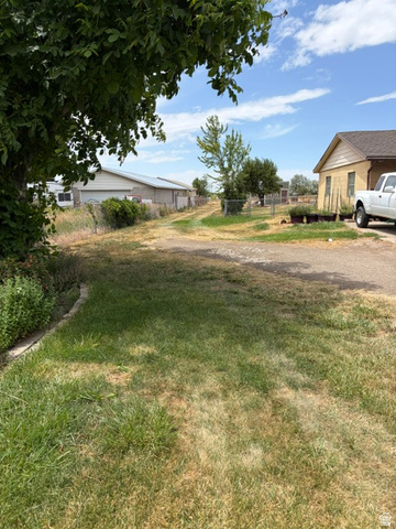 Fort Lane Layton, UT 84041 - Photo 3 of 4 Expansive outdoor space featuring a paved driveway and varied landscaping
