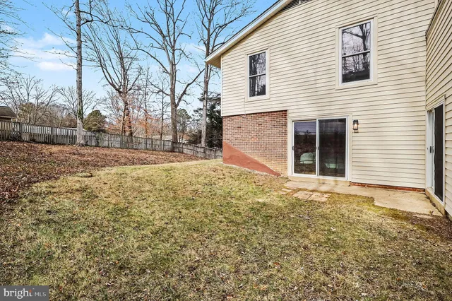 a view of a house with a yard covered in snow