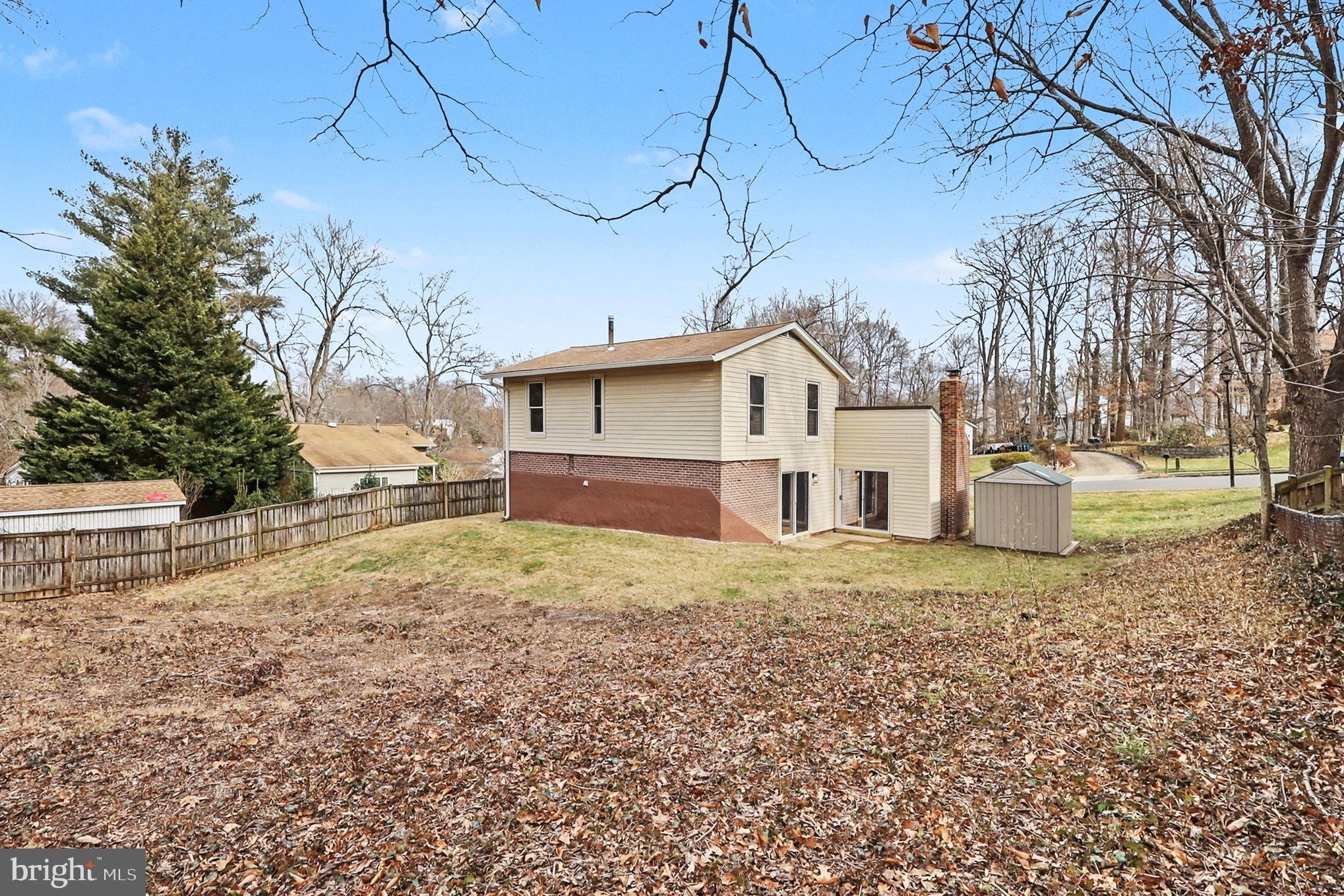6214 Garretson Street Burke, VA 22015 - Photo 22 of 27 a view of a house with a yard covered in snow