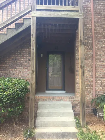 a front view of a house with a garden