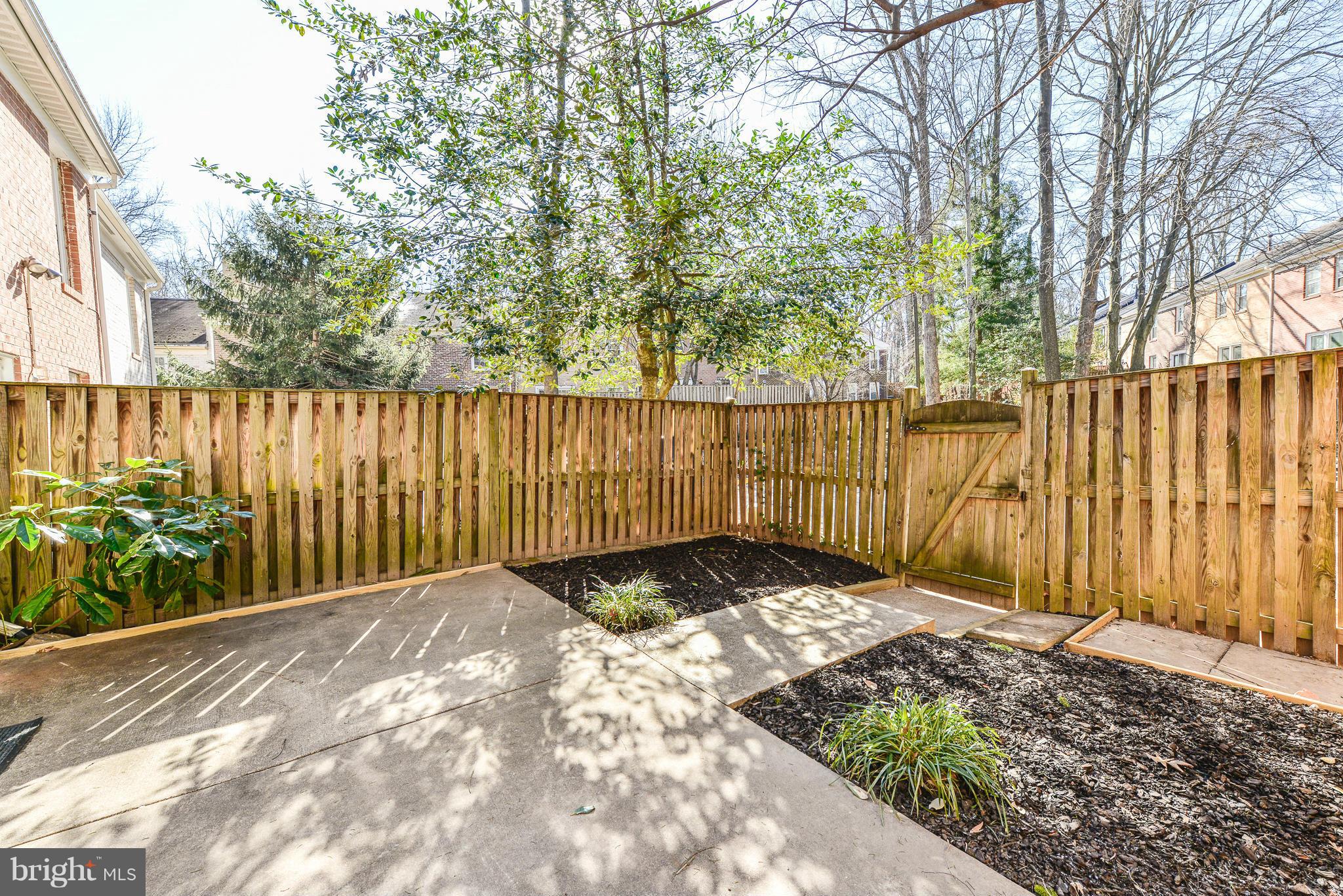 2407 Alsop Court Reston, VA 20191 - Photo 13 of 30 a view of backyard with wooden fence and large trees