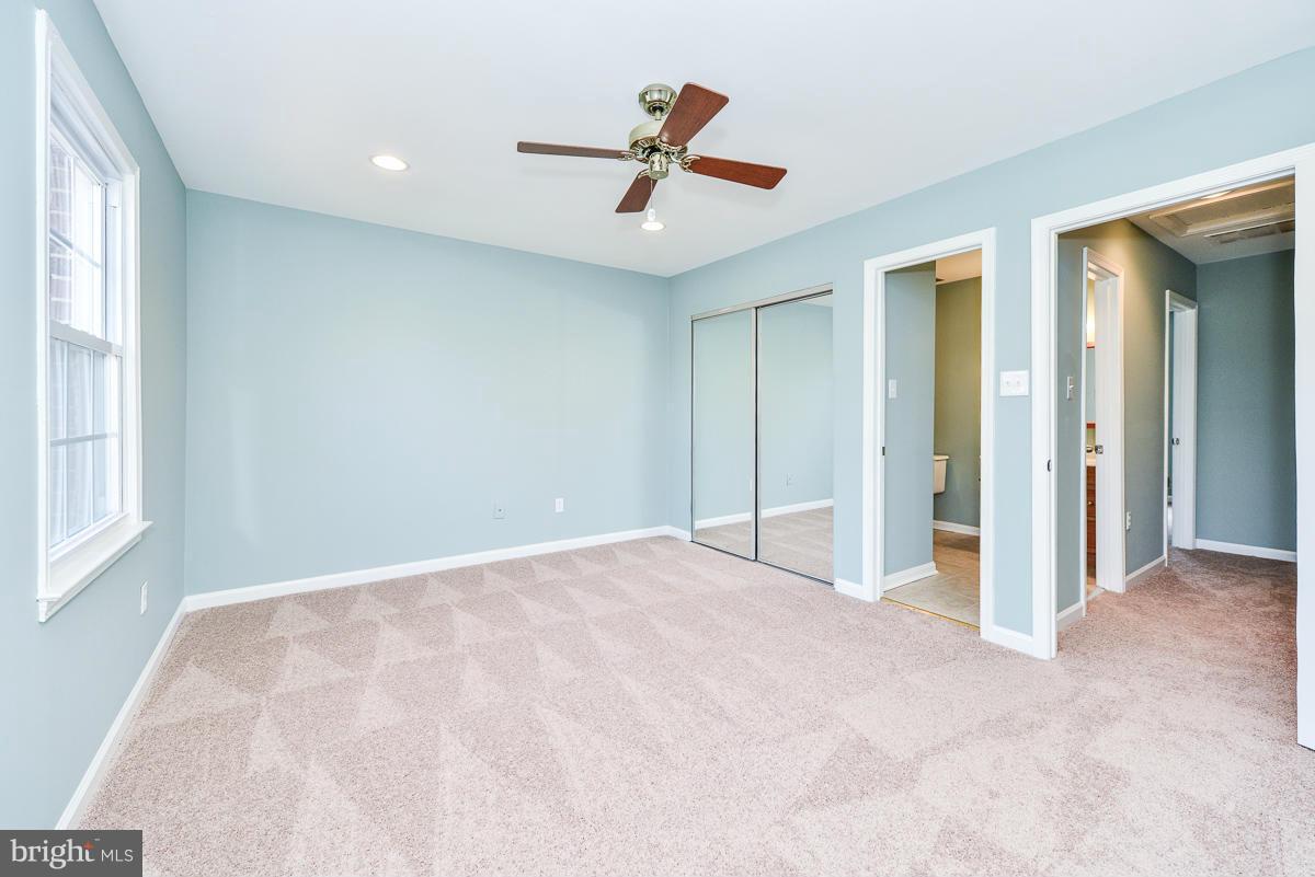 2407 Alsop Court Reston, VA 20191 - Photo 17 of 30 an empty room with ceiling fan and window