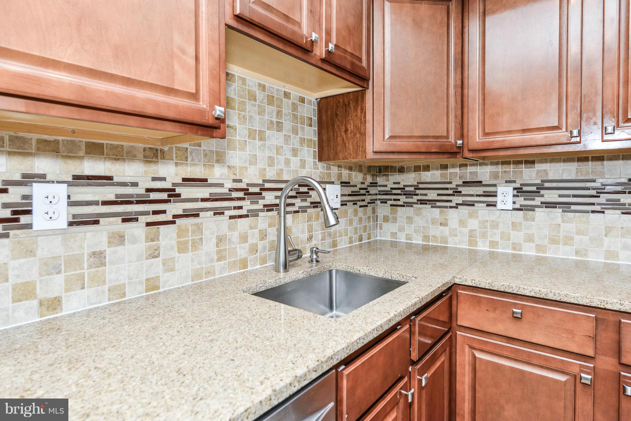 2407 Alsop Court Reston, VA 20191 - Photo 4 of 30 a kitchen with stainless steel appliances granite countertop a sink stove and cabinets