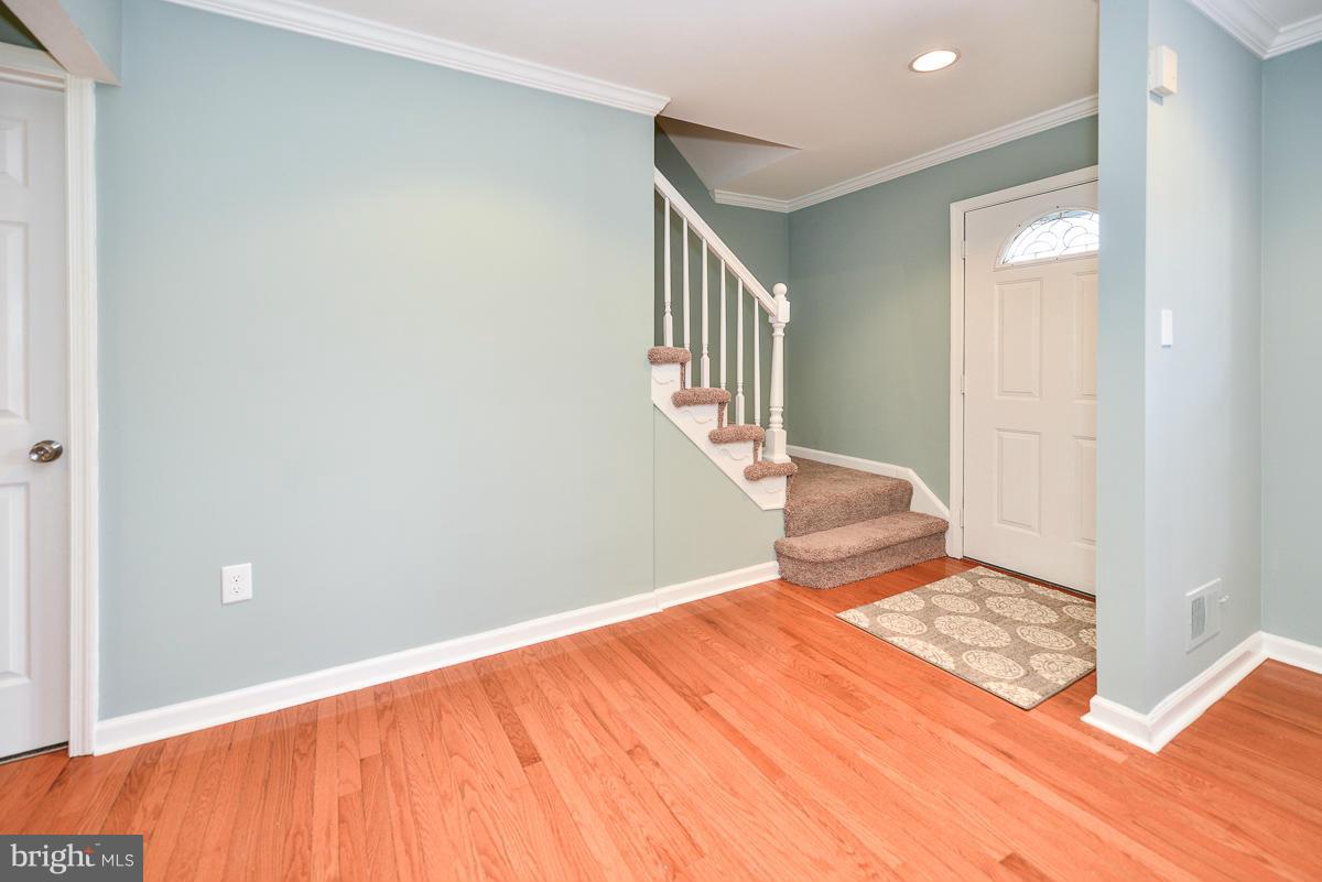 2407 Alsop Court Reston, VA 20191 - Photo 5 of 30 a bedroom with a bed and wooden floor
