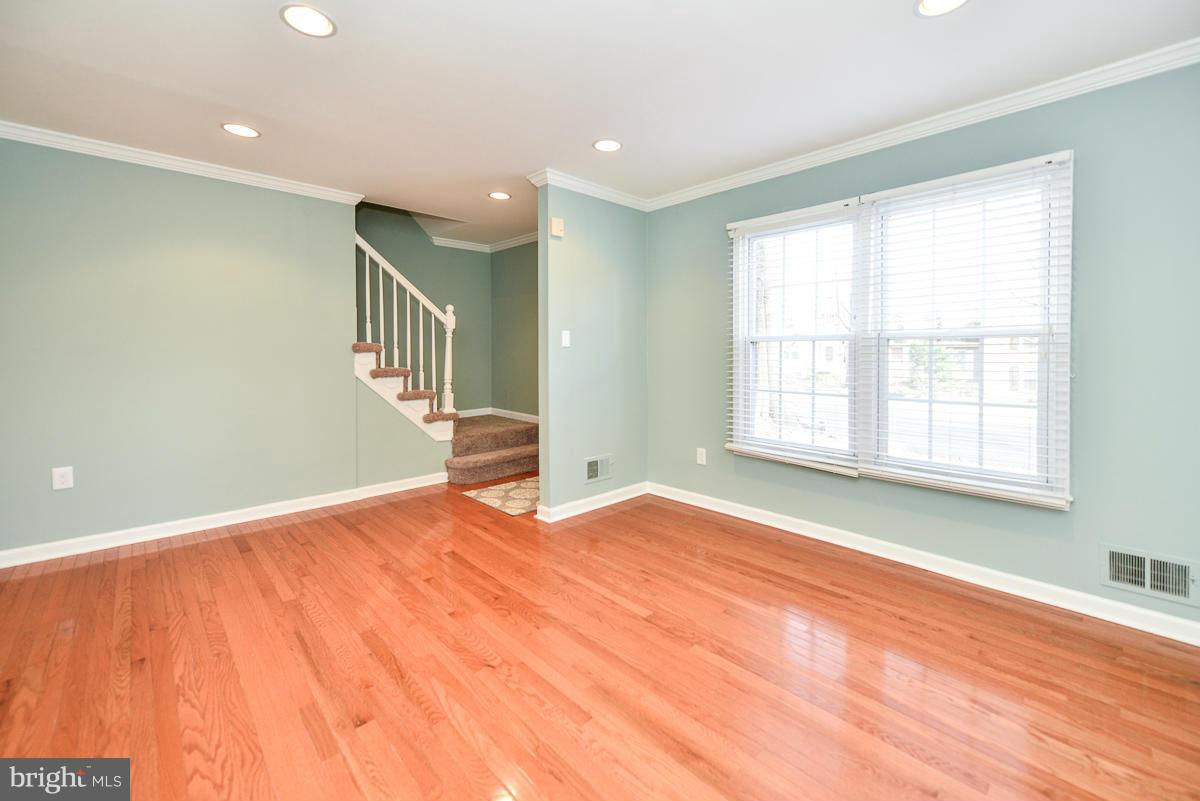 2407 Alsop Court Reston, VA 20191 - Photo 6 of 30 a view of an empty room with wooden floor and a window