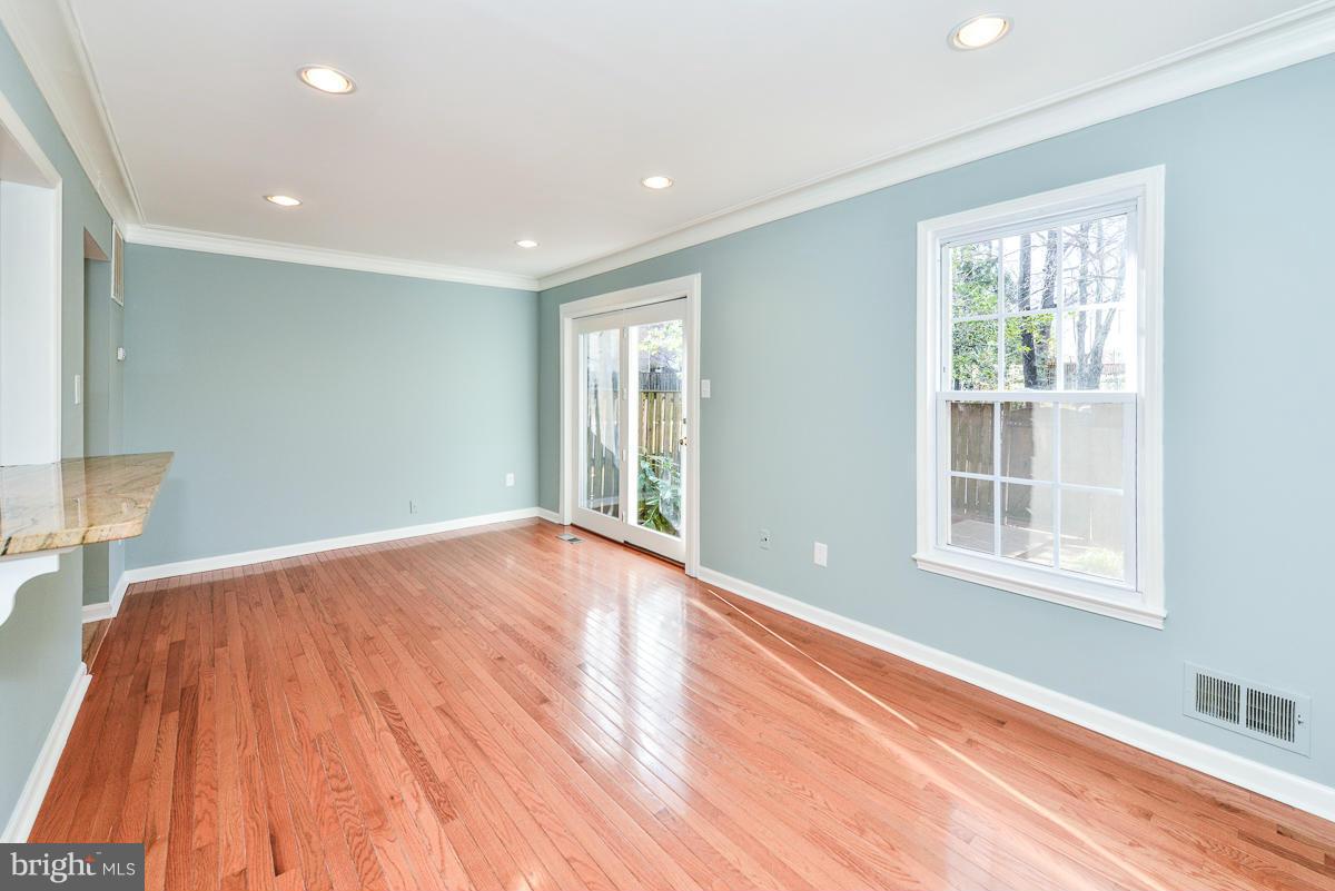 2407 Alsop Court Reston, VA 20191 - Photo 9 of 30 a view of an empty room with wooden floor and a window