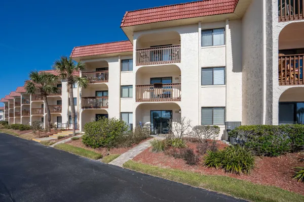 a front view of a building with garden