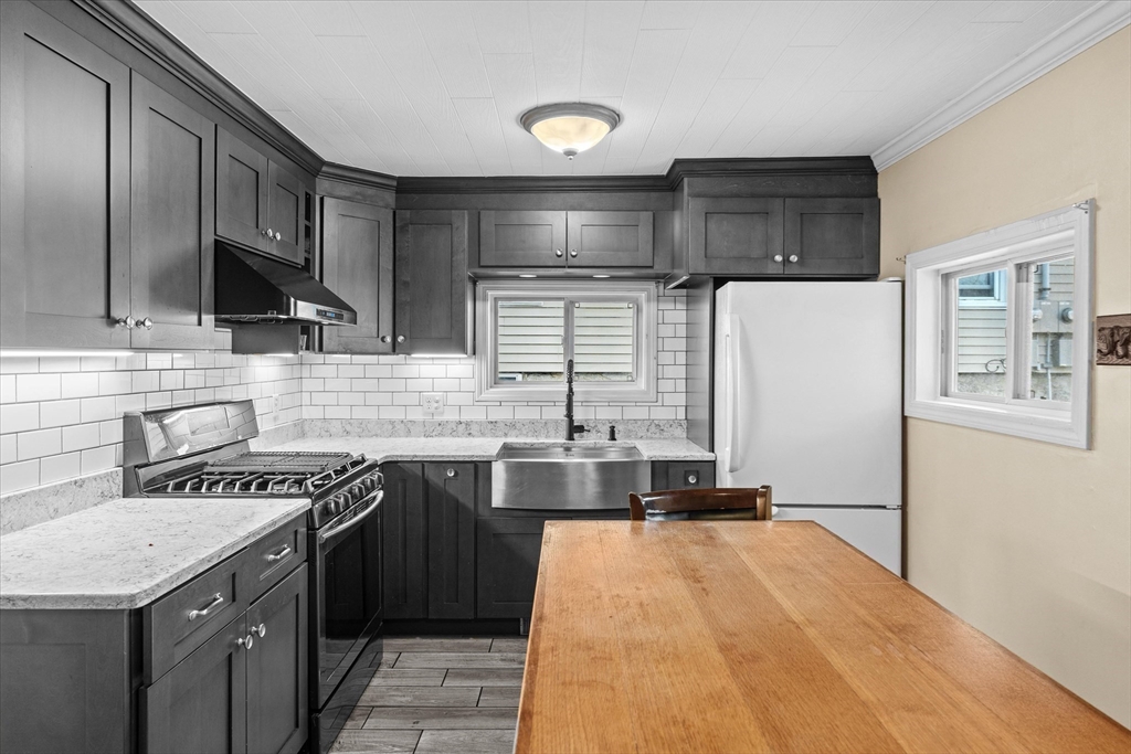 a kitchen with a sink stove and cabinets